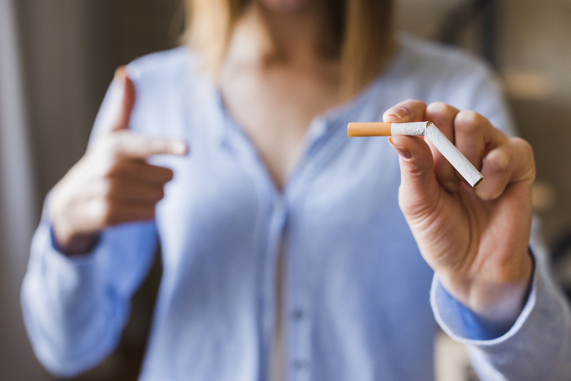 woman pointing at broken cigarette