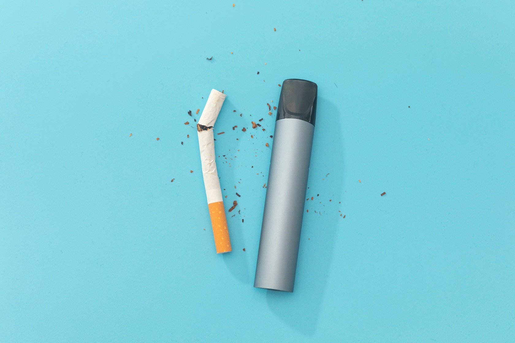 Electronic cigarettes and tobacco on blue background. Quit smo